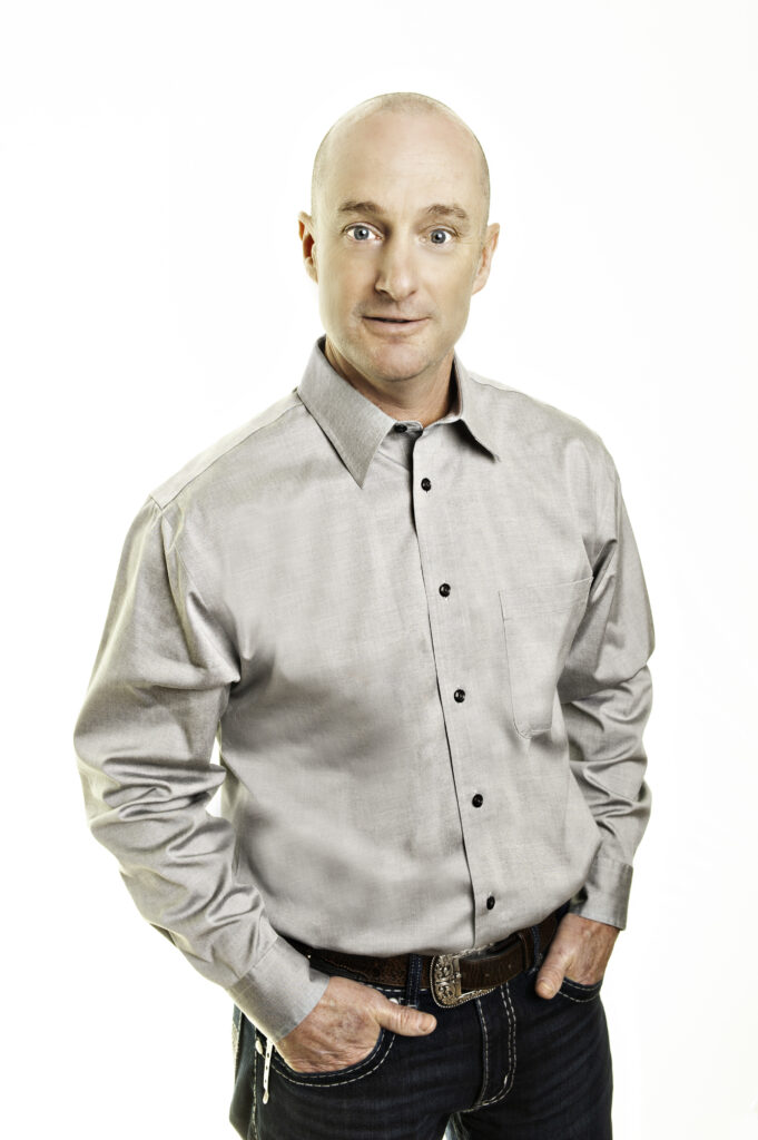 Grant LaMarsh, Broker Owner of 2% Realty Platinum standing with his hands in his pocket against a white background for the page About 2% Realty 