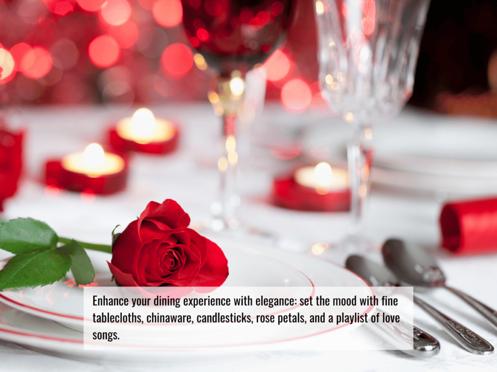 An elegant table setting with a white table cloth, red candles and a red rose.