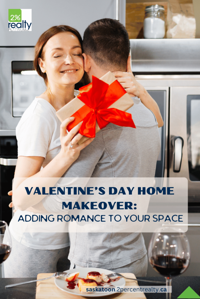 A couple sharing a hug in their kitchen and the woman is holding a gift box with a red bow. The text overlay reads 'Valentine's Day Home Makeover: Adding Romance to Your Space'